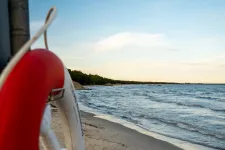  lifebuoy in foreground, beach and ocean in background. photo